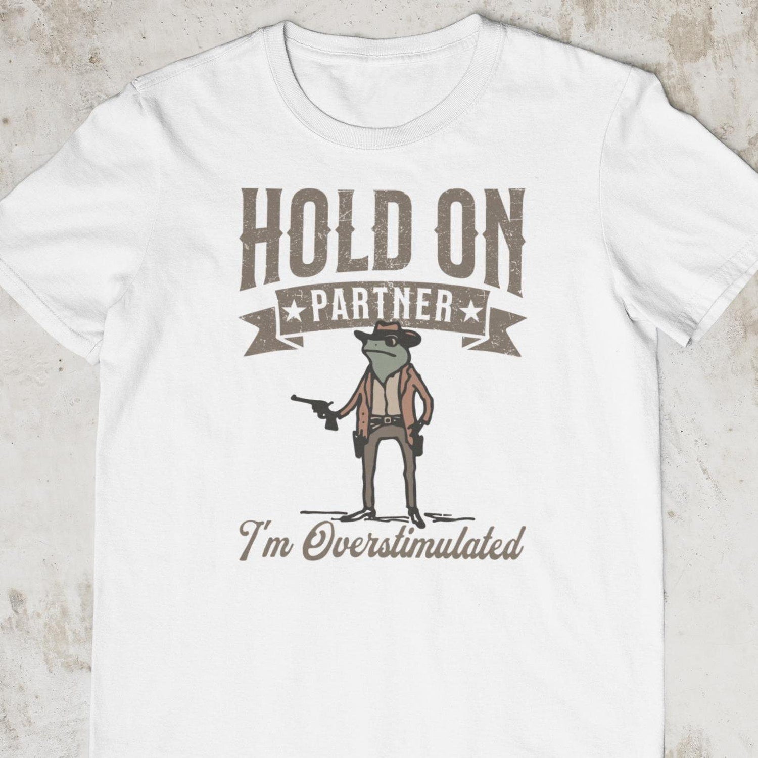 'Hold On Partner I'm Overstimulated' Frog Western Tee - Funny Meme Graphic Novelty Shirt